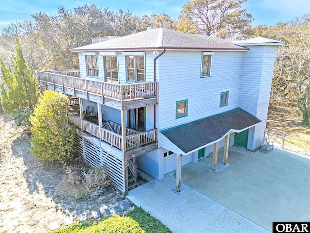 rear view of property with a shingled roof