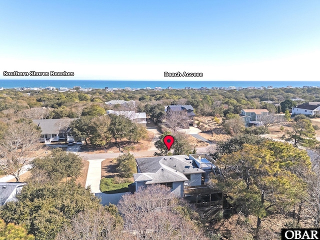 drone / aerial view with a water view and a residential view