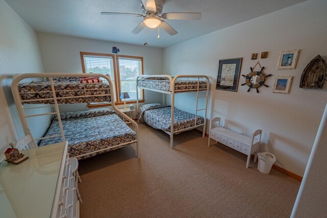 bedroom featuring ceiling fan, carpet floors, and baseboards