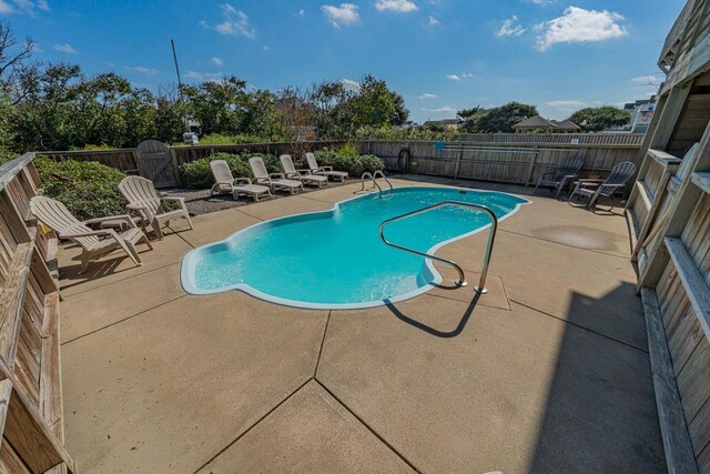 view of swimming pool featuring a fenced backyard, a fenced in pool, and a patio