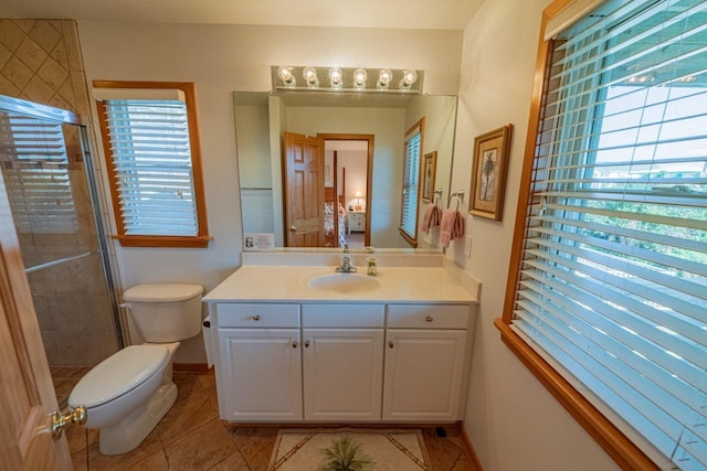 bathroom featuring toilet, a stall shower, connected bathroom, vanity, and tile patterned flooring