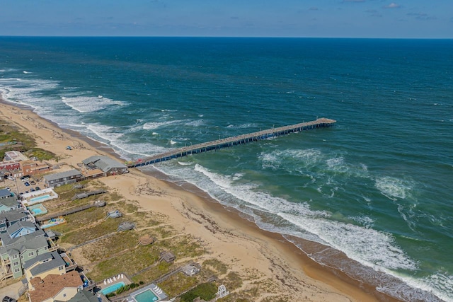 birds eye view of property featuring a water view and a beach view