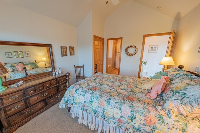 carpeted bedroom featuring high vaulted ceiling and visible vents