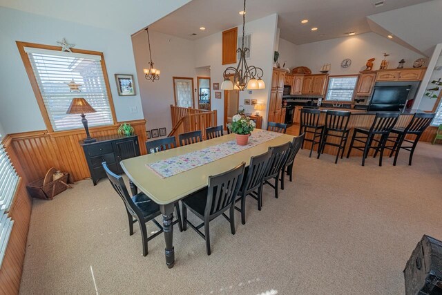 dining room featuring light colored carpet, wainscoting, wood walls, a chandelier, and recessed lighting