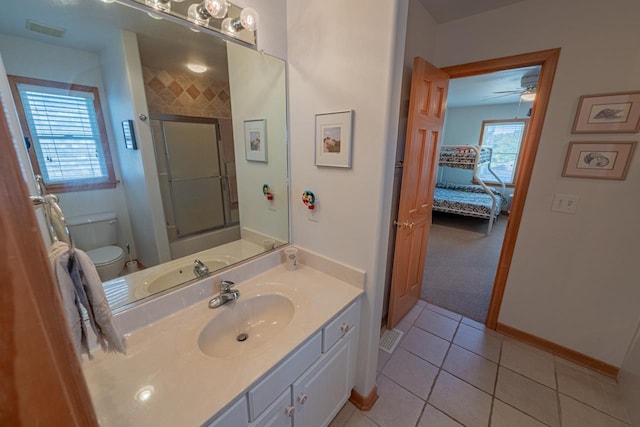 ensuite bathroom featuring visible vents, toilet, tile patterned floors, an enclosed shower, and vanity