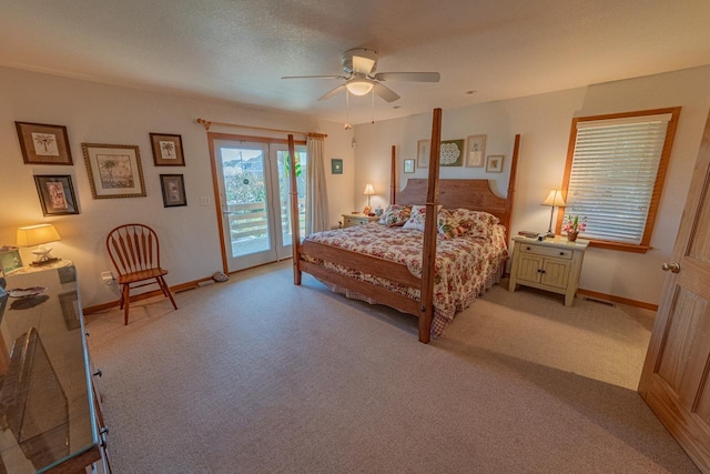 bedroom with access to outside, light colored carpet, and baseboards