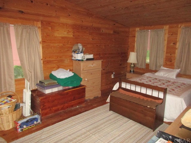 bedroom featuring lofted ceiling, wood ceiling, and wooden walls