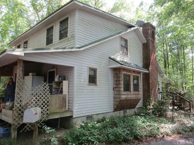 view of home's exterior with a chimney