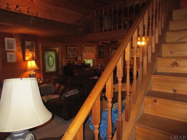 stairs featuring wooden walls