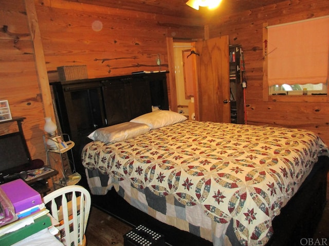 bedroom featuring wood walls