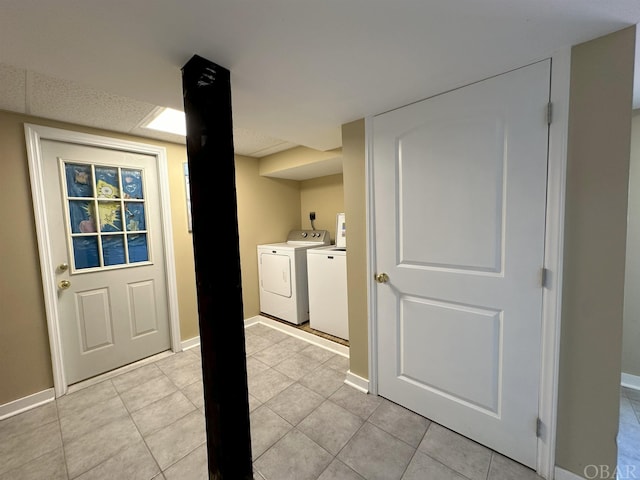 interior space featuring laundry area, washer and clothes dryer, and baseboards