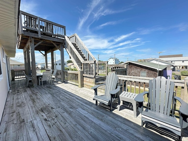 wooden terrace with outdoor dining area