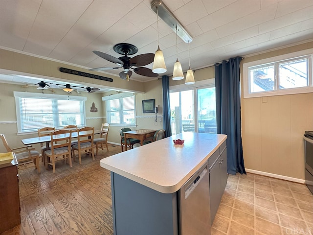 kitchen featuring a kitchen island, ornamental molding, dishwasher, light wood finished floors, and decorative light fixtures