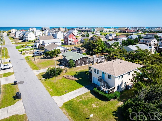 drone / aerial view featuring a residential view and a water view