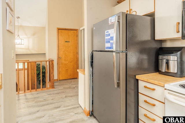1133 Payson St Lot 120, Corolla, NC 27927 - kitchen featuring freestanding refrigerator, light wood-type flooring, range, light countertops, and white cabinets