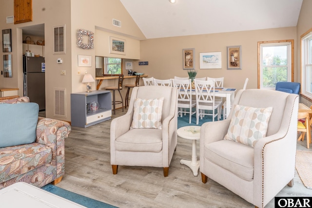 1133 Payson St Lot 120, Corolla, NC 27927 - living area featuring vaulted ceiling, healthy amount of natural light, and wood finished floors