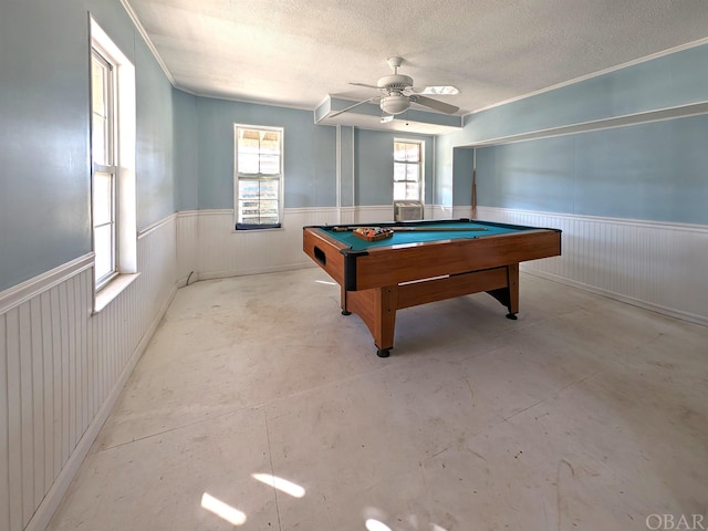 rec room featuring a textured ceiling, concrete floors, wainscoting, and billiards