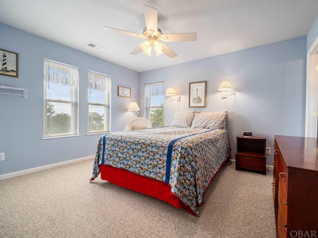 bedroom with a ceiling fan, carpet flooring, visible vents, and baseboards