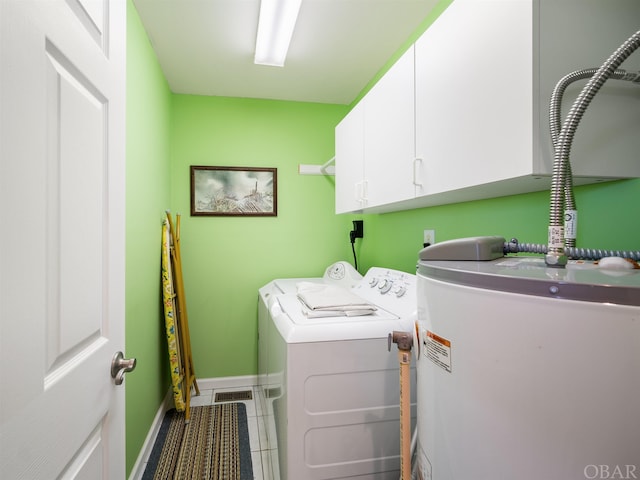 laundry room featuring water heater, cabinet space, separate washer and dryer, baseboards, and tile patterned floors