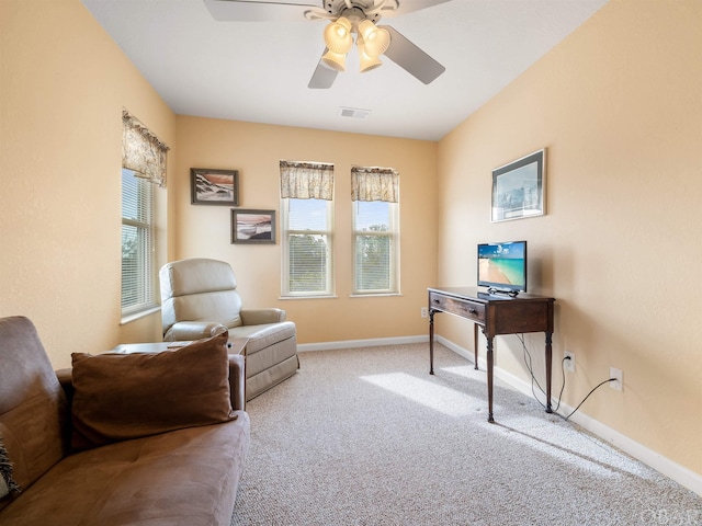 office area with light carpet, ceiling fan, visible vents, and baseboards