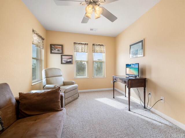 office area with light carpet, ceiling fan, visible vents, and baseboards