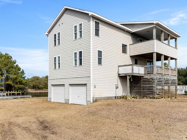 exterior space featuring a balcony, driveway, and a garage