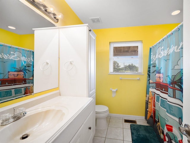 full bathroom featuring toilet, vanity, baseboards, visible vents, and tile patterned floors