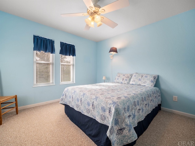 carpeted bedroom with ceiling fan and baseboards