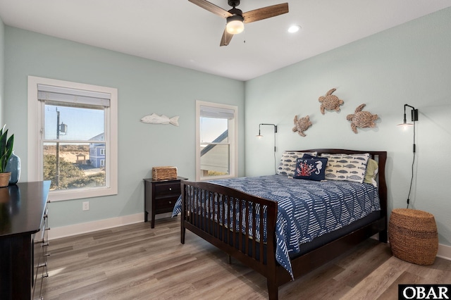 bedroom with recessed lighting, light wood-style floors, baseboards, and ceiling fan