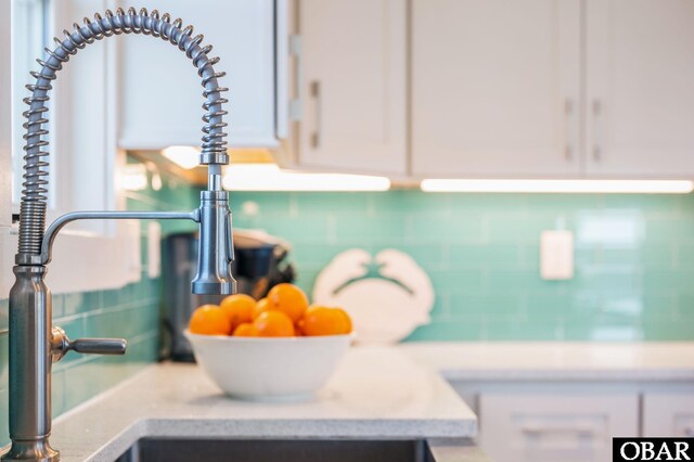 room details featuring white cabinetry and light countertops