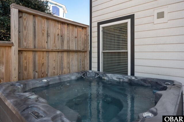 exterior details with a hot tub