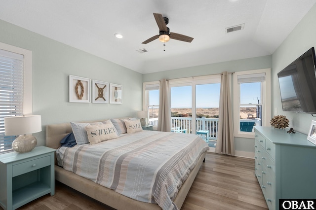 bedroom with access to exterior, visible vents, and light wood-style flooring