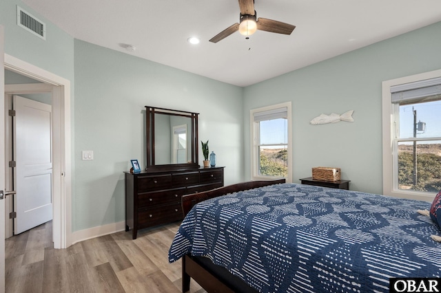 bedroom with a ceiling fan, visible vents, baseboards, recessed lighting, and light wood-style floors