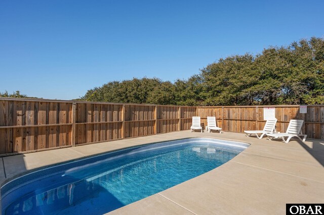 view of swimming pool with a patio area, a fenced backyard, and a fenced in pool