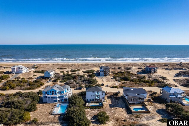 aerial view featuring a view of the beach and a water view