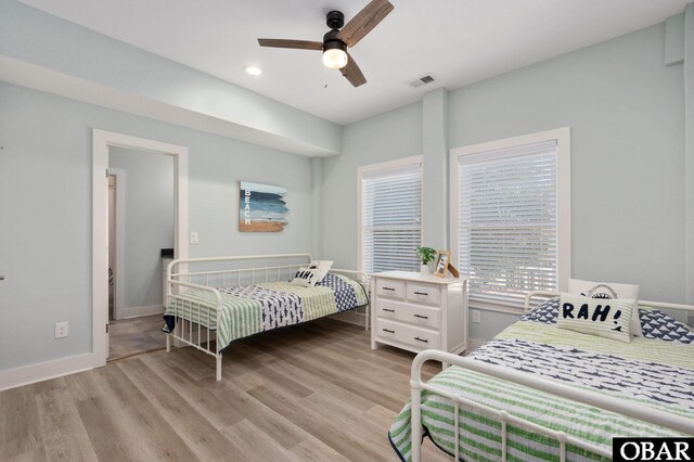 bedroom with a ceiling fan, baseboards, visible vents, light wood finished floors, and recessed lighting