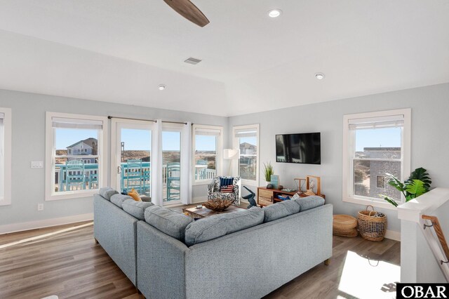 living area featuring visible vents, plenty of natural light, and wood finished floors