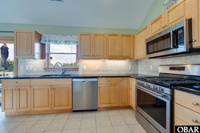 117 Four Seasons Ln Lot 12, Duck, NC 27949 - kitchen featuring appliances with stainless steel finishes, light brown cabinets, light tile patterned flooring, and lofted ceiling