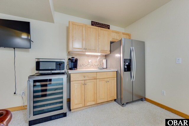 117 Four Seasons Ln Lot 12, Duck, NC 27949 - kitchen with appliances with stainless steel finishes, wine cooler, light brown cabinets, light colored carpet, and tasteful backsplash