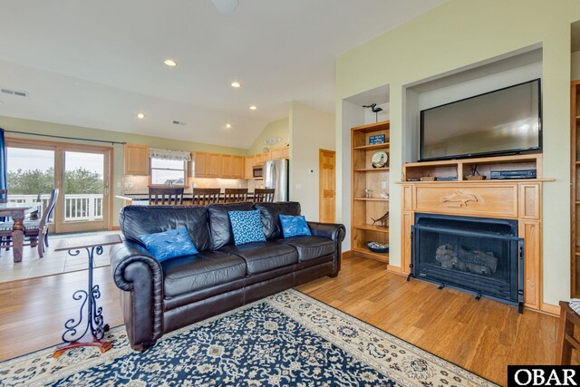 117 Four Seasons Ln Lot 12, Duck, NC 27949 - living area featuring light wood-style floors, lofted ceiling, a fireplace, recessed lighting, and built in features