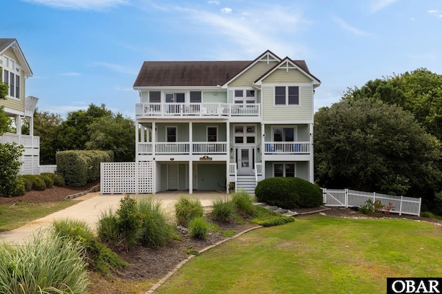 117 Four Seasons Ln Lot 12, Duck, NC 27949 - rear view of house featuring a balcony, a gate, driveway, and stairs