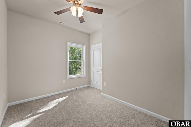 empty room featuring baseboards, visible vents, ceiling fan, and light colored carpet