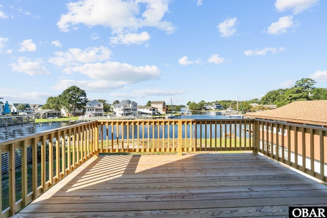 deck featuring a residential view and a water view