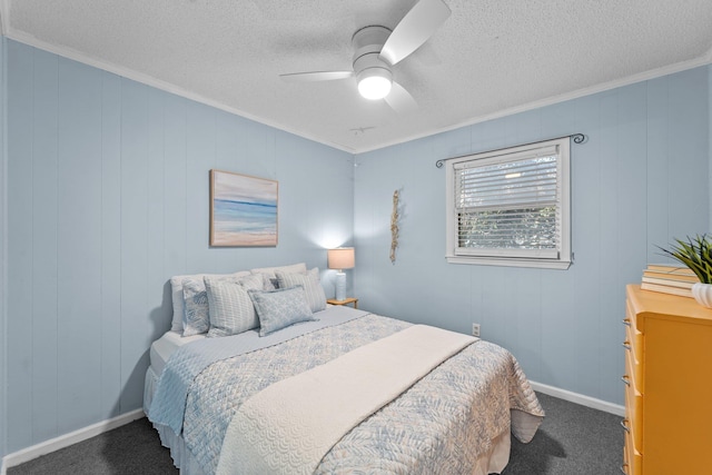 bedroom with baseboards, ceiling fan, ornamental molding, dark colored carpet, and a textured ceiling