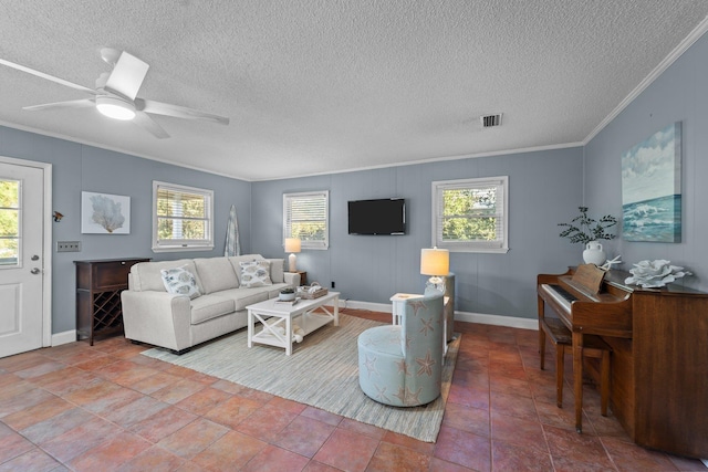 living area featuring visible vents, ornamental molding, ceiling fan, a textured ceiling, and baseboards