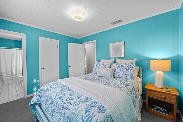 carpeted bedroom with a textured ceiling, ornamental molding, connected bathroom, and visible vents