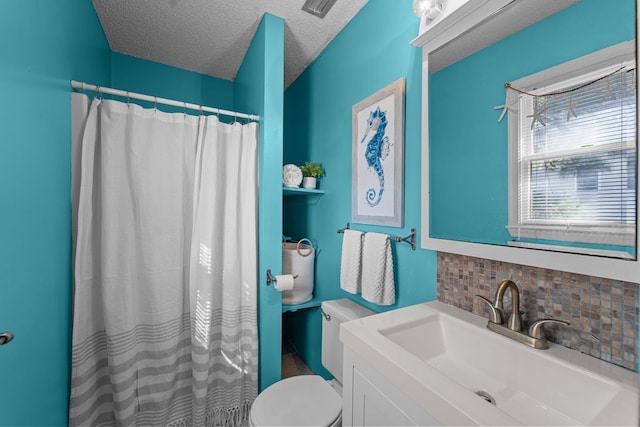 bathroom featuring a textured ceiling, tasteful backsplash, vanity, and toilet