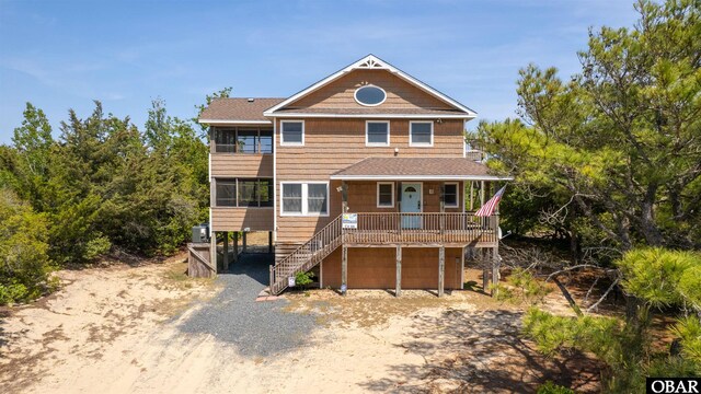 2319 Carova Rd Lot # 22, Corolla, NC 27927 - view of front of home featuring stairs, driveway, covered porch, and an attached garage