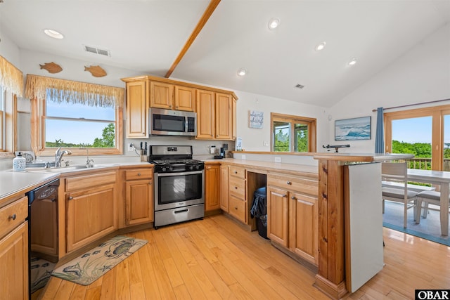 2319 Carova Rd Lot # 22, Corolla, NC 27927 - kitchen featuring appliances with stainless steel finishes, a peninsula, healthy amount of natural light, light countertops, and lofted ceiling