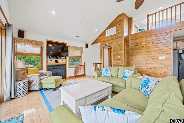 2319 Carova Rd Lot # 22, Corolla, NC 27927 - living room with light wood-style floors, ceiling fan, high vaulted ceiling, wood walls, and recessed lighting